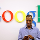 A visitor uses a cellphone in front of the Google logo Sept. 26, 2012, at the official opening party of Google offices in Berlin.
Adam Berry/Getty Images